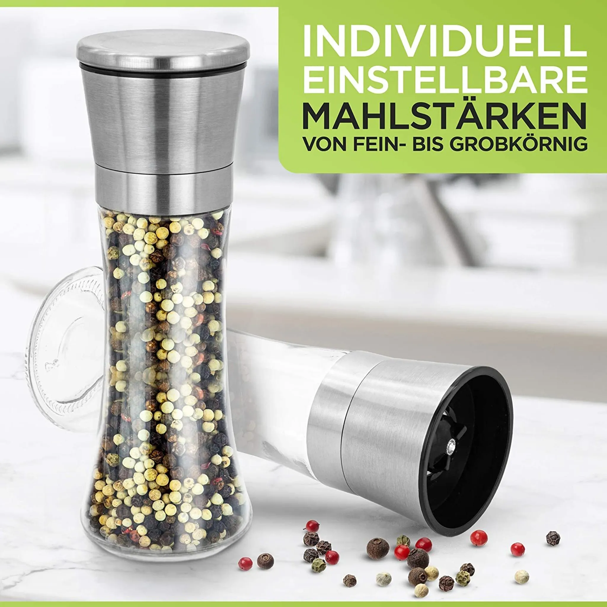 Edelstahl-Pfeffermühle mit Glasbehälter, gefüllt mit Pfefferkörnern.