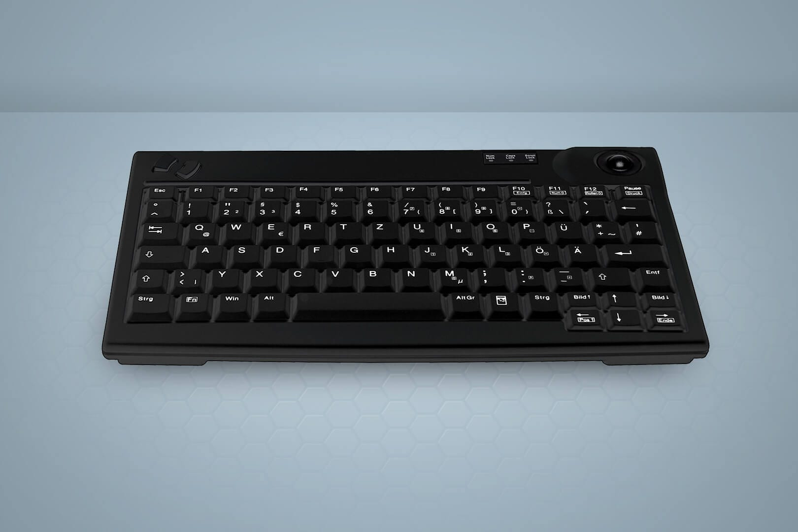 Teclado negro con trackball en la parte superior derecha, con etiquetas de teclas alemanas.