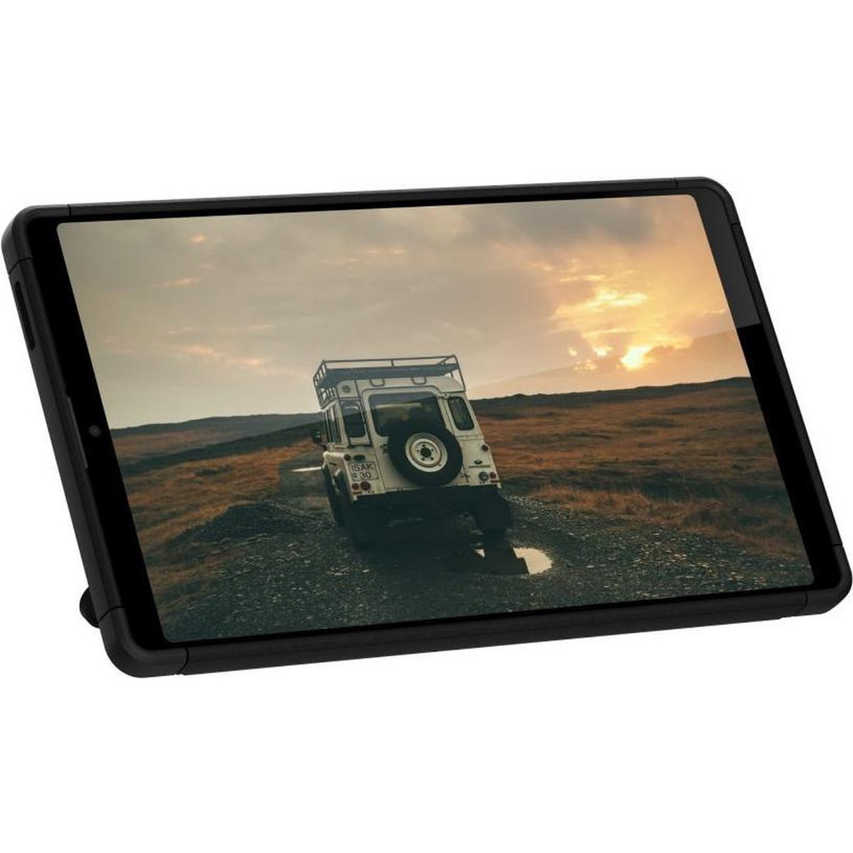 White off-road vehicle on a dirt road at sunset.