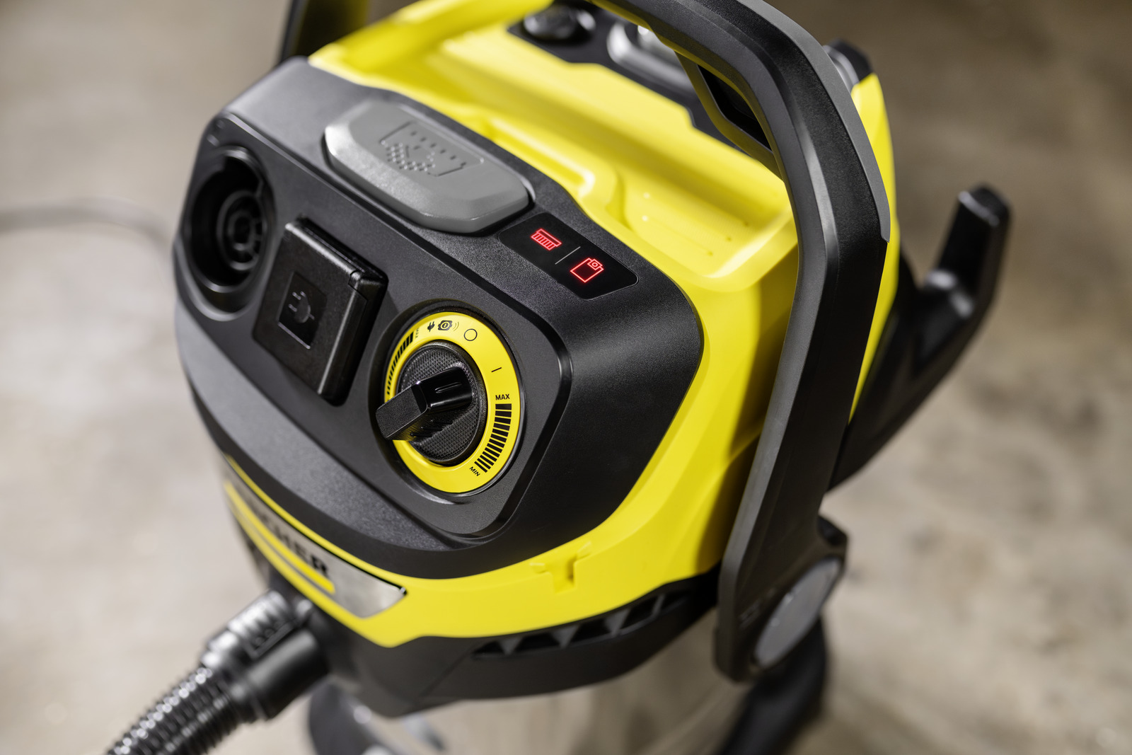 Yellow vacuum cleaner with black handle and controls, red indicator lights.