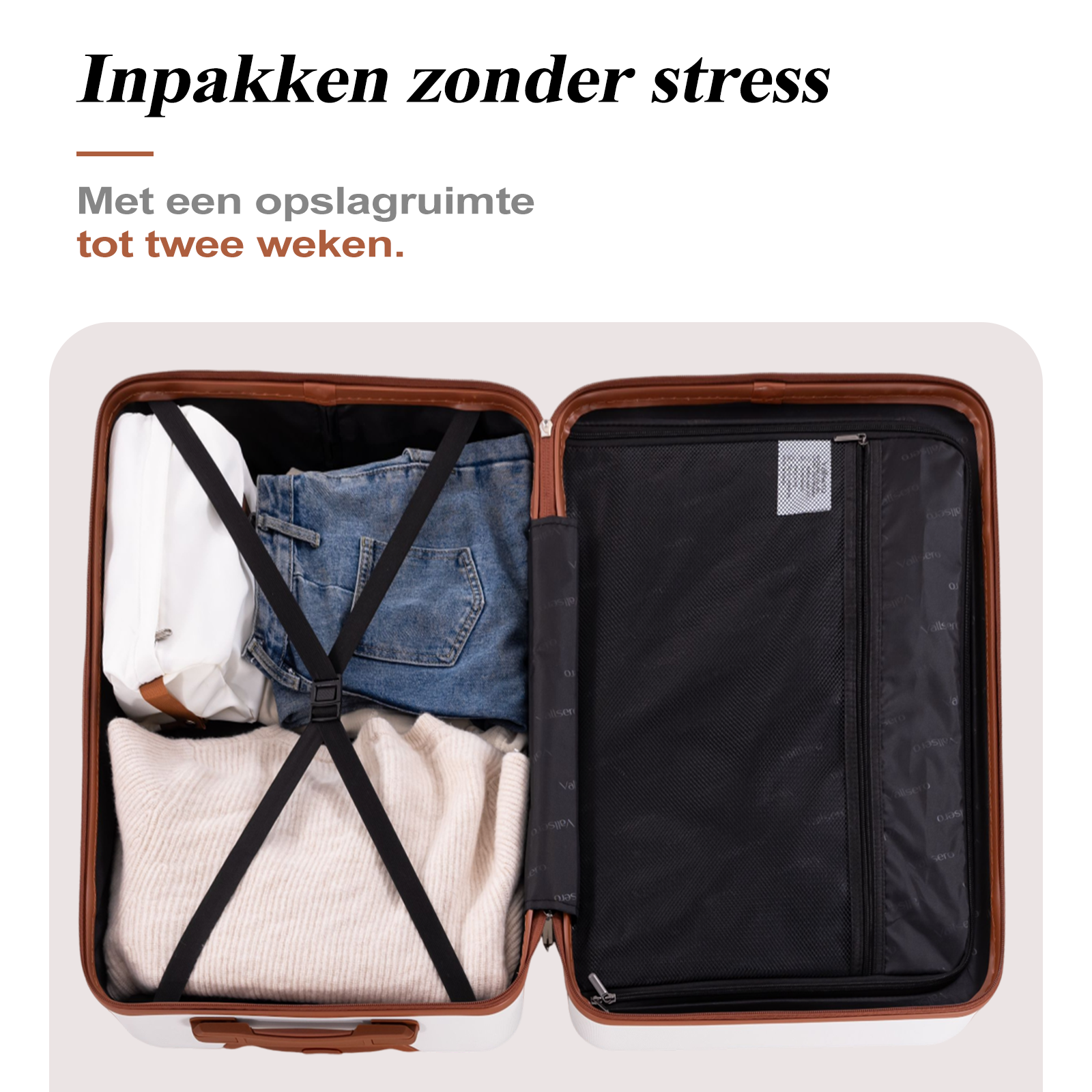 Open suitcase with clothes: sweater, jeans, and a white bag.
