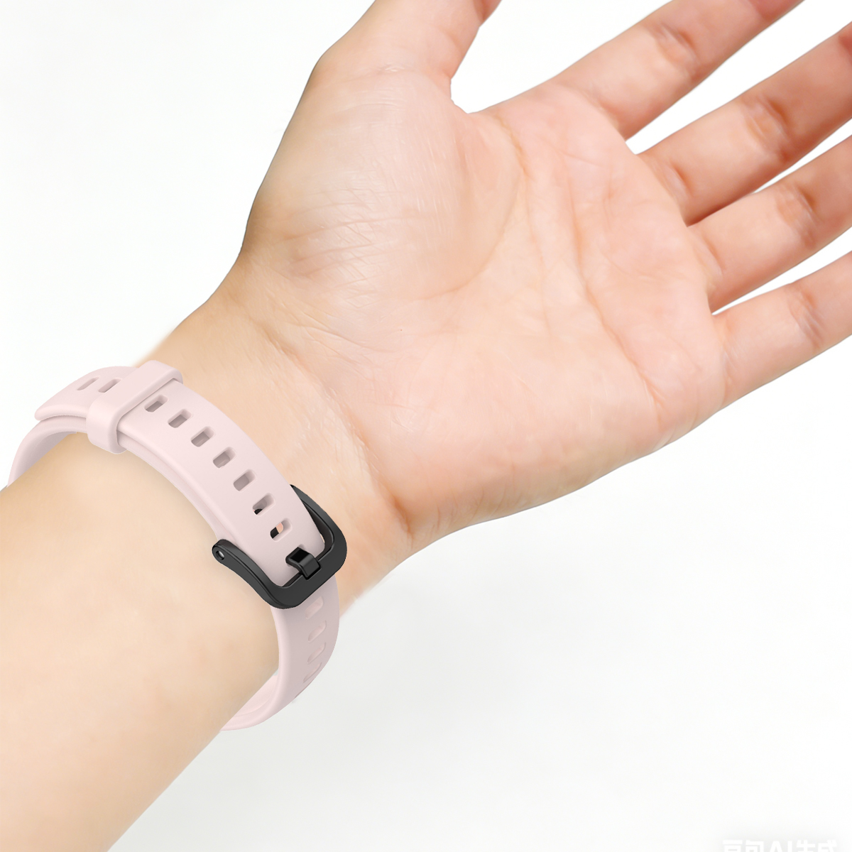 Ein hellrosa Armband mit schwarzer Schnalle an einem Handgelenk.