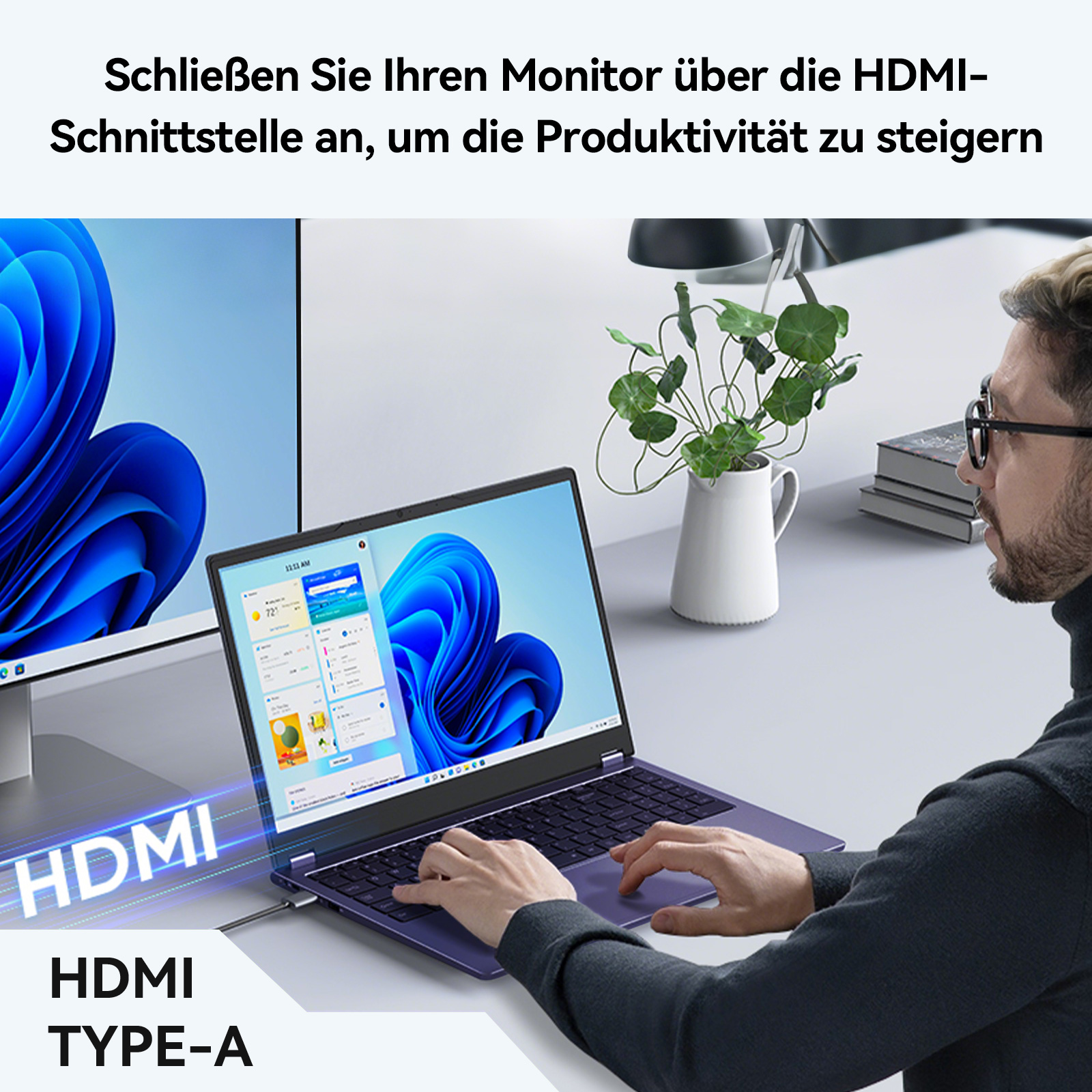 Ein Mann schließt einen lila Laptop über HDMI an einen Monitor an.