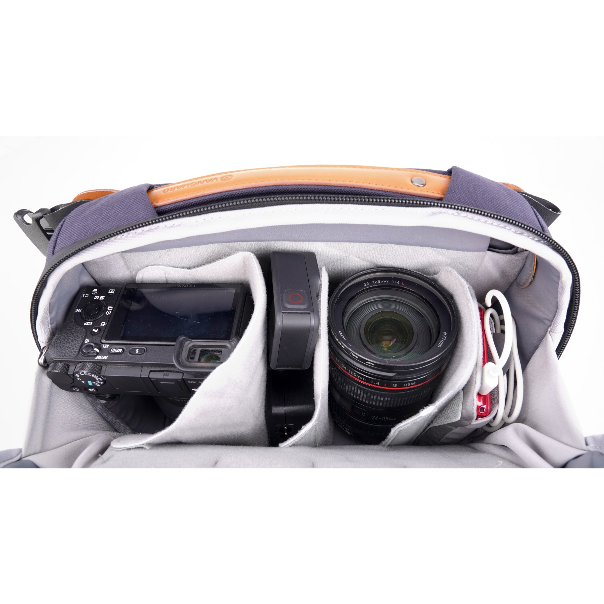 Bolso de cámara abierto con cámara Sony, GoPro, lente y audífonos.