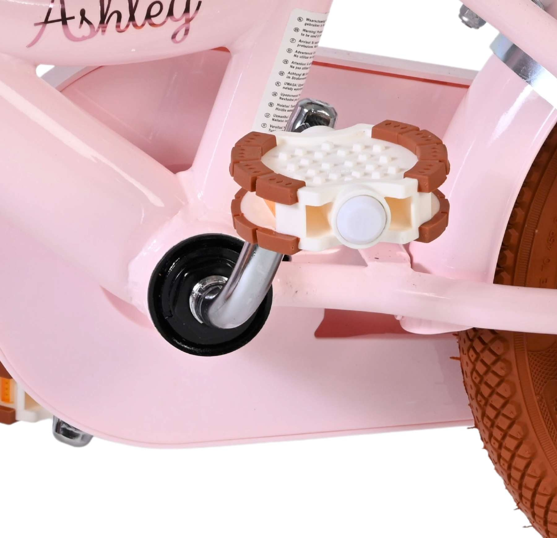 Nahaufnahme eines rosa Kinderfahrrads mit Pedalen und einem Rad.
