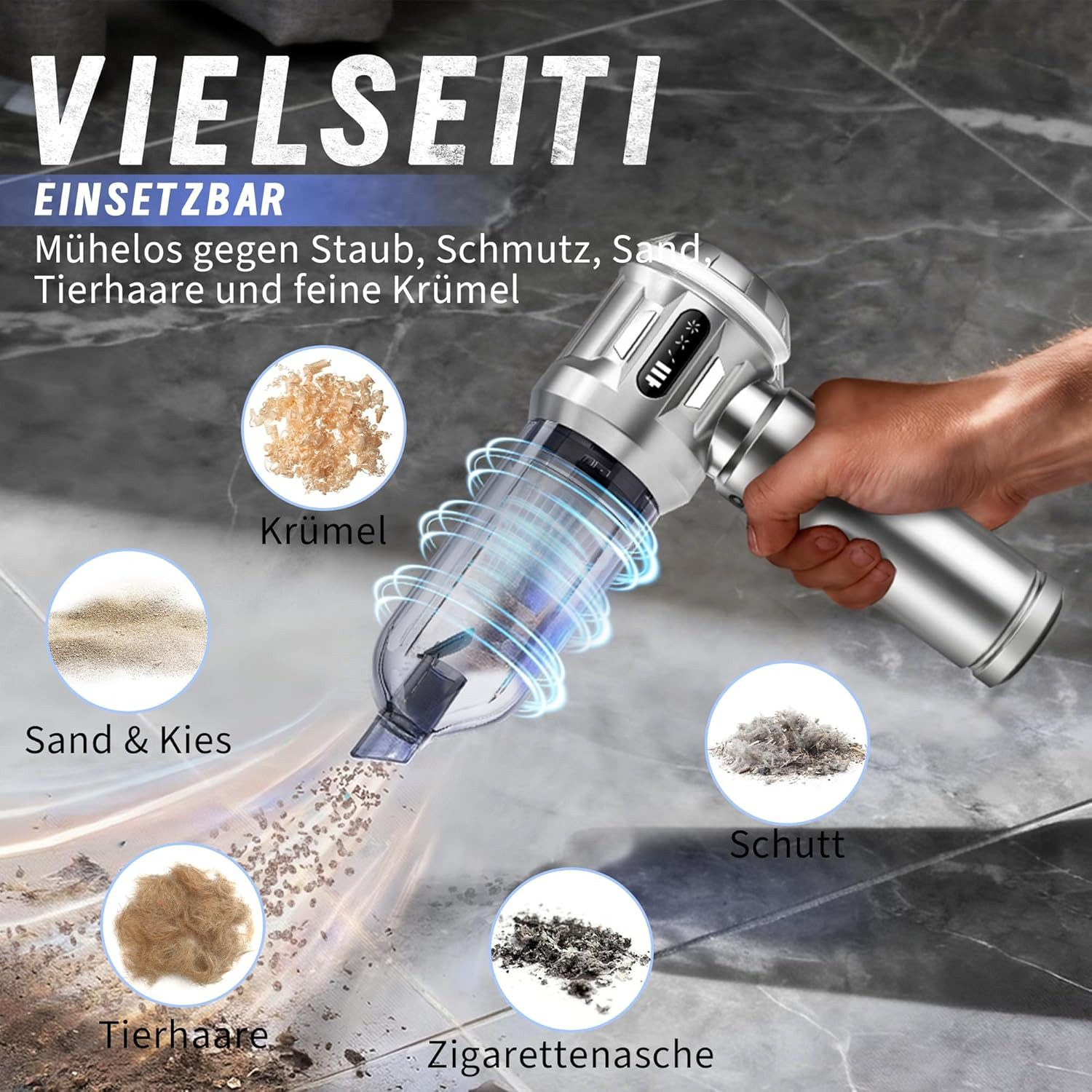 Dłoń trzyma srebrny odkurzacz, zasysa okruchy, piasek, sierść, śmieci, popiół.