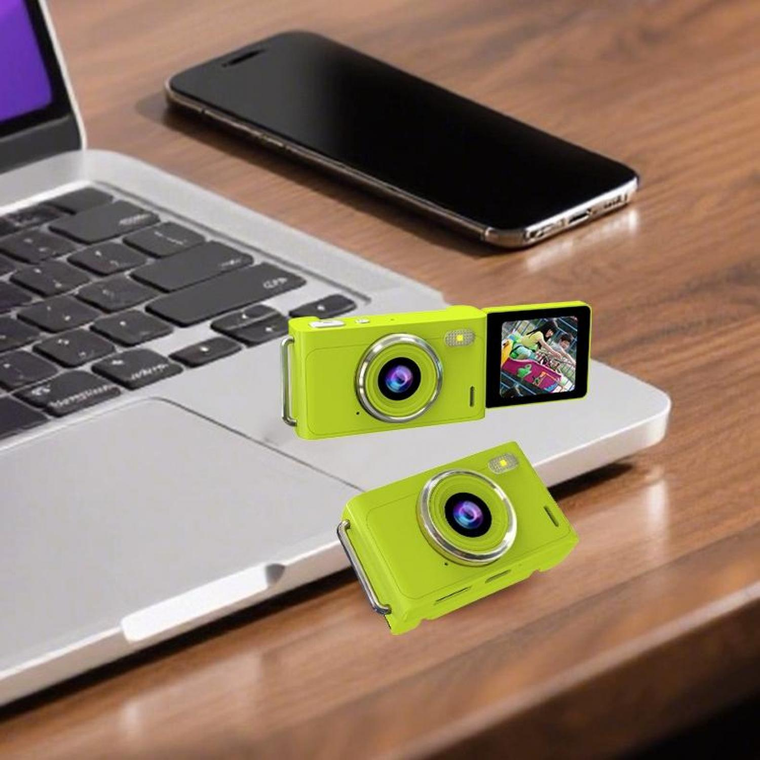 Zwei grüne Kameras auf einem Laptop mit Smartphone dahinter.
