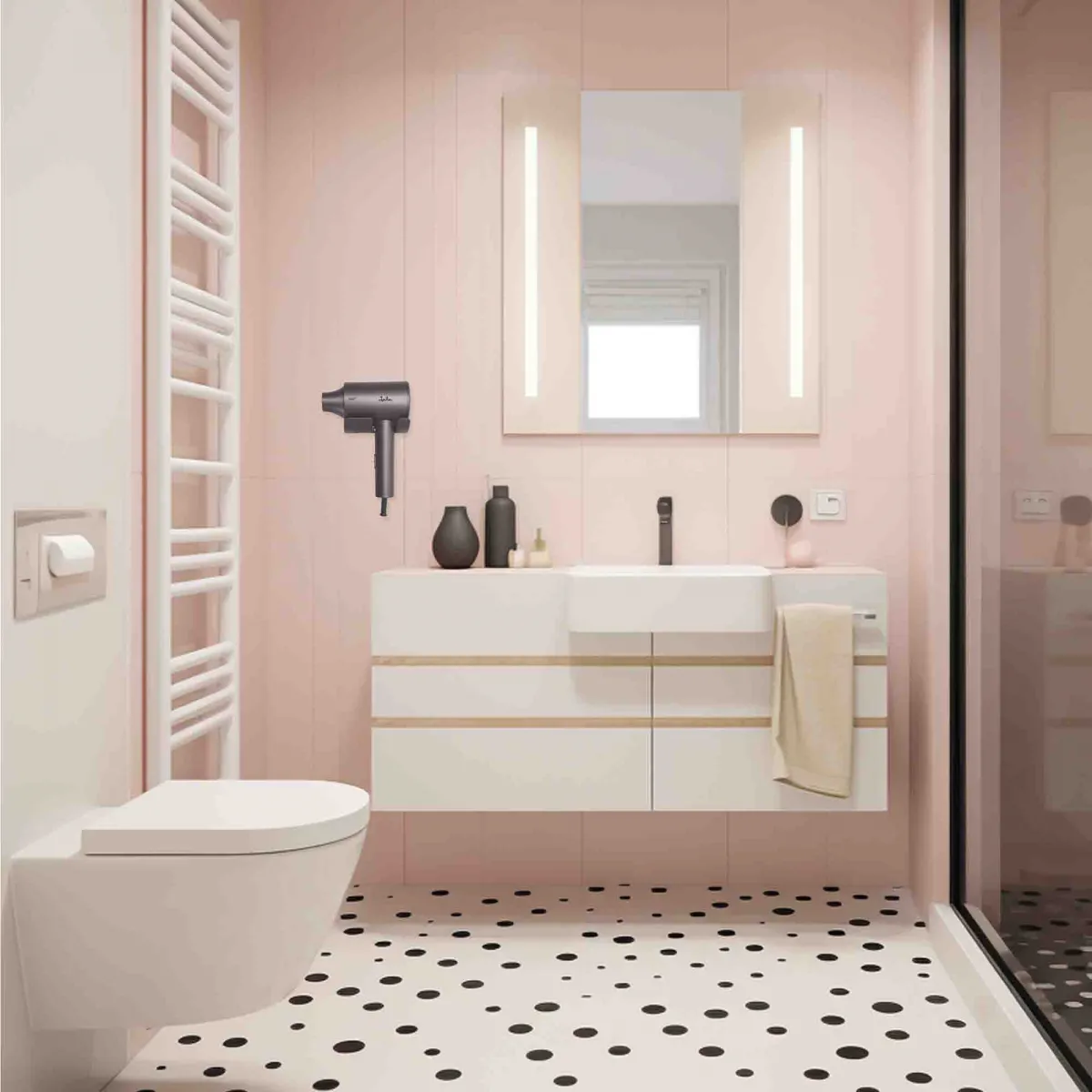 Un baño moderno con secador de pelo, inodoro, lavabo y espejo.