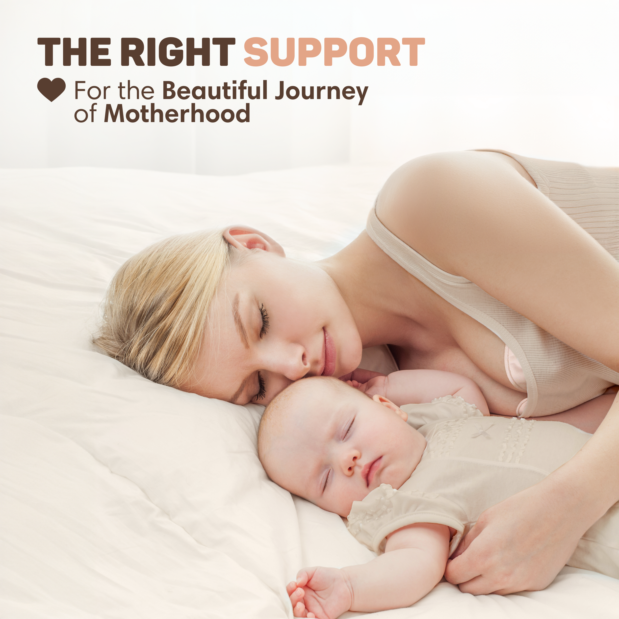 A woman and a baby sleep nestled closely together on a white bed.