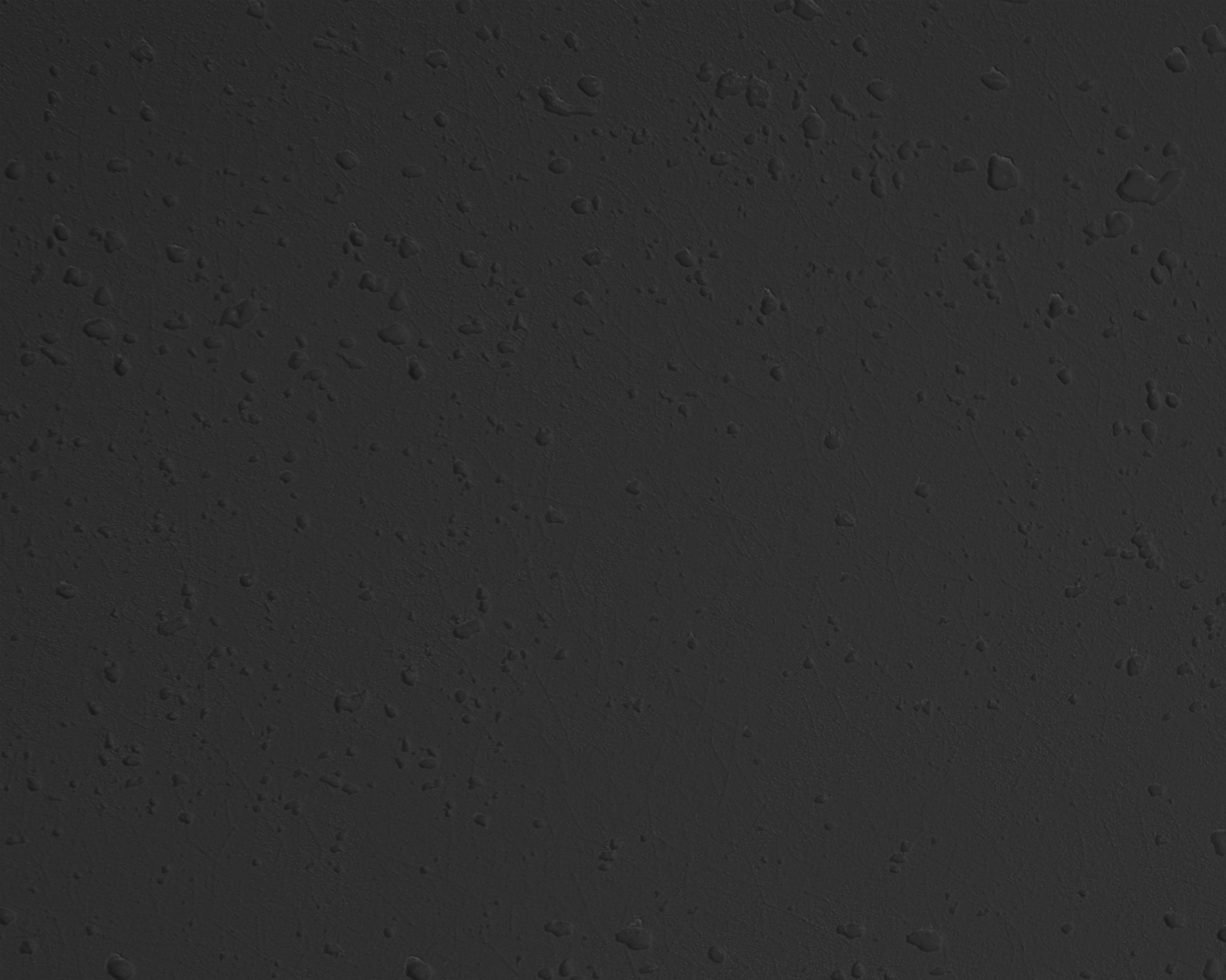 Dunkelgrauer Hintergrund mit kleinen, unregelmäßigen Wasserflecken.