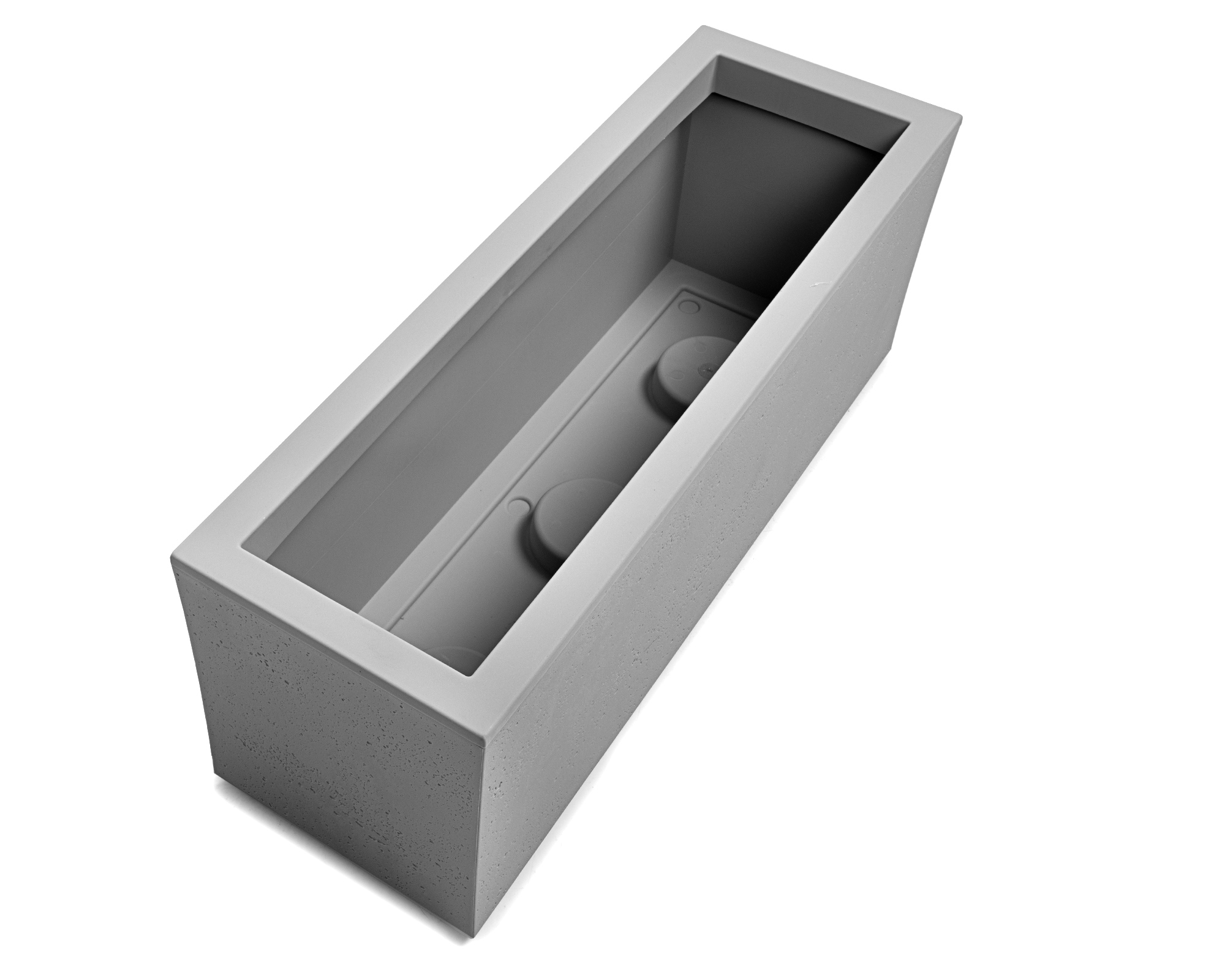 Grauer Beton-Blumenkasten mit zwei inneren runden Erhebungen.