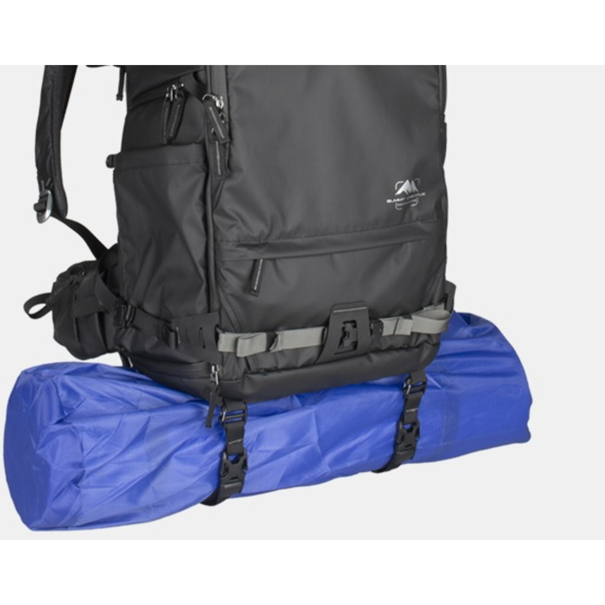 Ein schwarzer Rucksack ist über einer blauen Rolle befestigt.