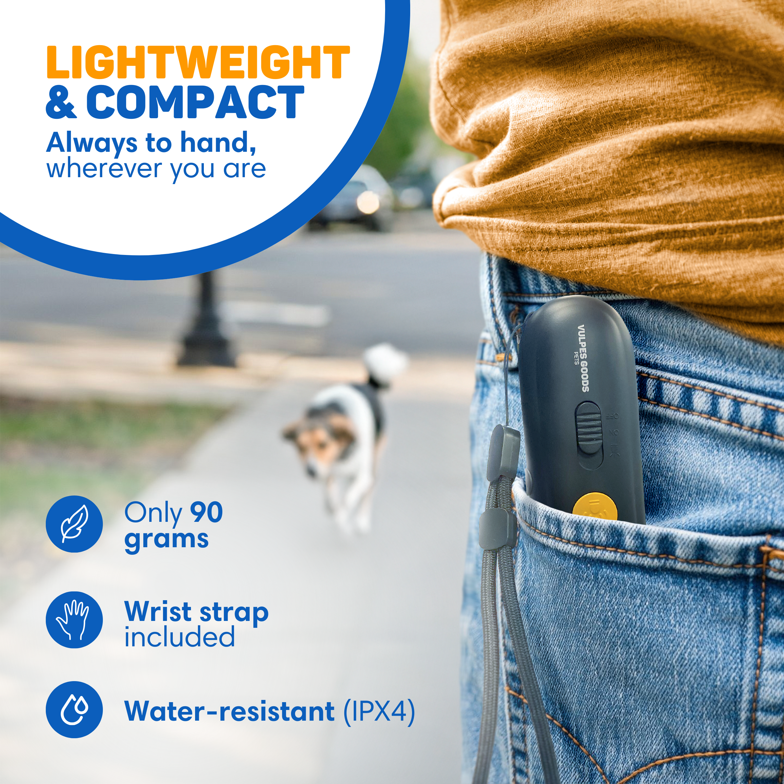 A black device with a yellow button is in a jeans pocket. A dog is blurred in the background.