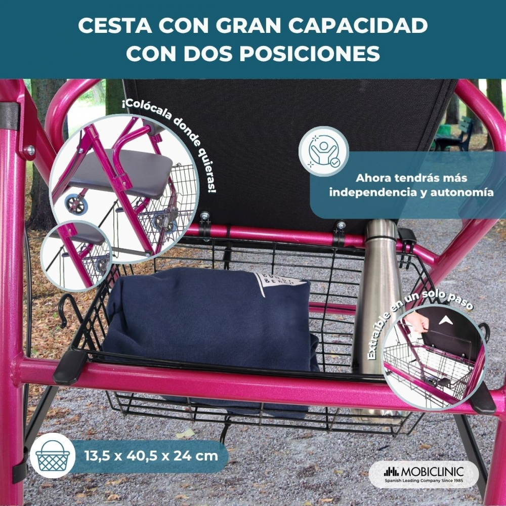 Un andador rosa con una cesta que contiene ropa y una botella.