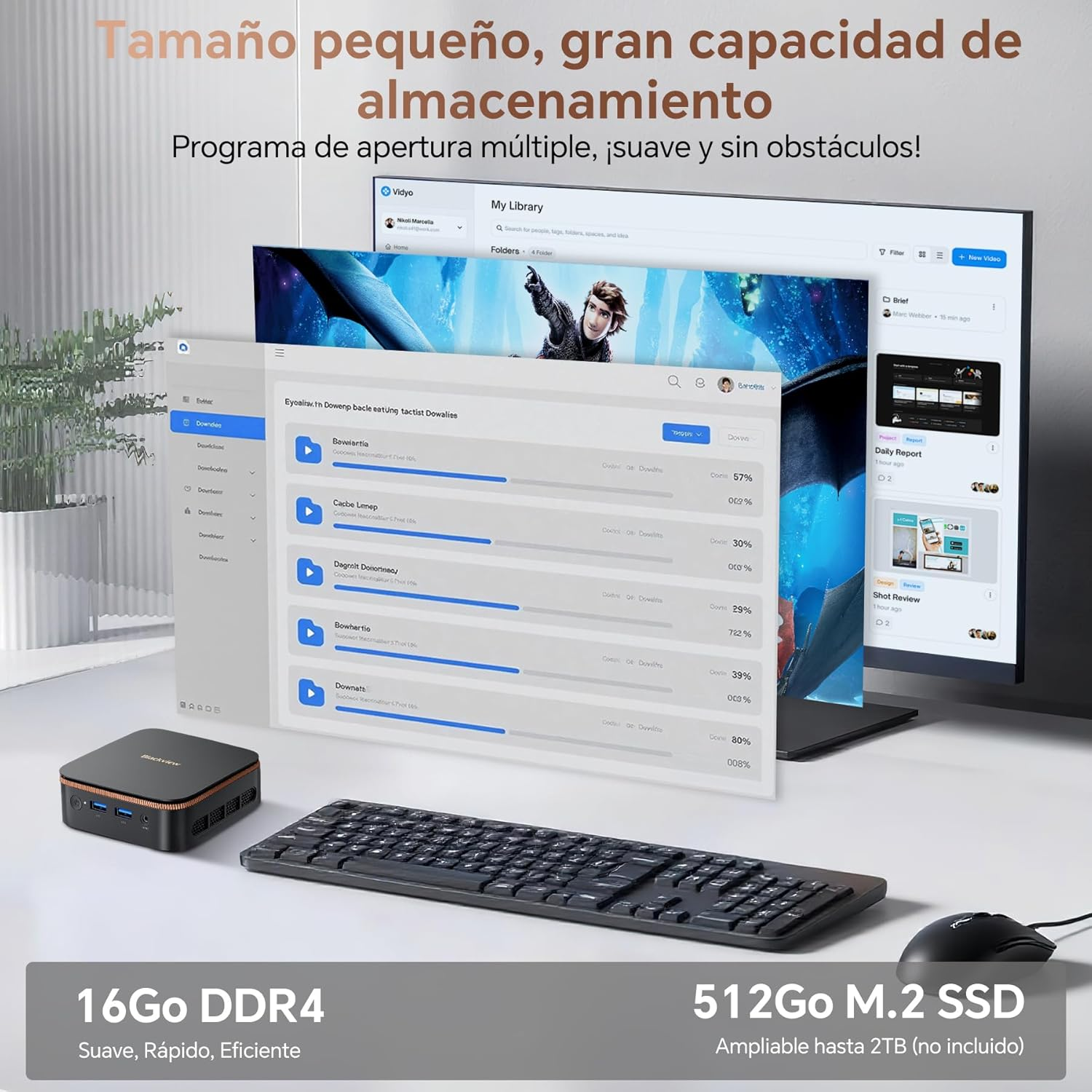 Un PC pequeño, teclado y ratón frente a una pantalla con interfaces de usuario.