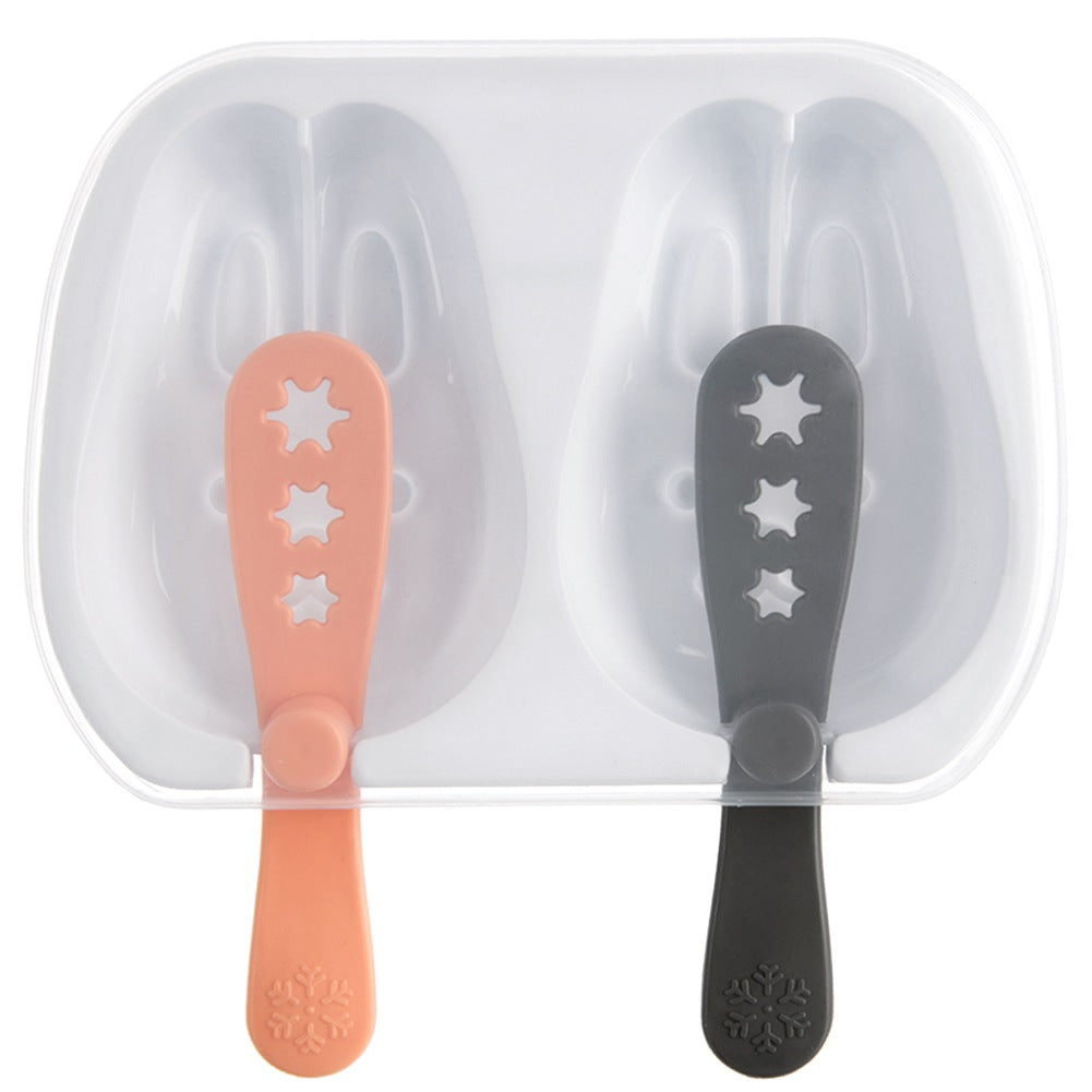 Un molde para paletas de hielo de dos cavidades con mangos rosa y gris.