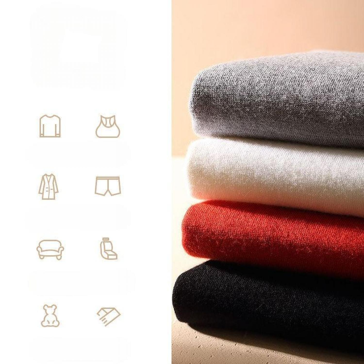 Ein Stapel Pullover in Grau, Weiß, Rot und Schwarz.