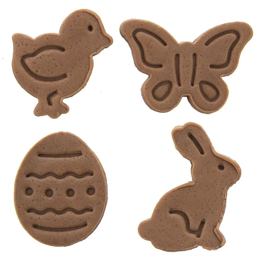 Galletas de Pascua marrones con forma de pollito, mariposa, huevo y conejo.