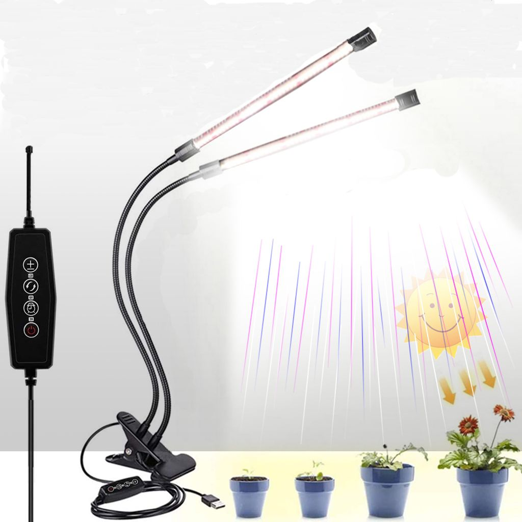 Eine Pflanzenlampe mit zwei biegsamen Armen und einem Controller steht neben vier kleinen Pflanzen in Töpfen.