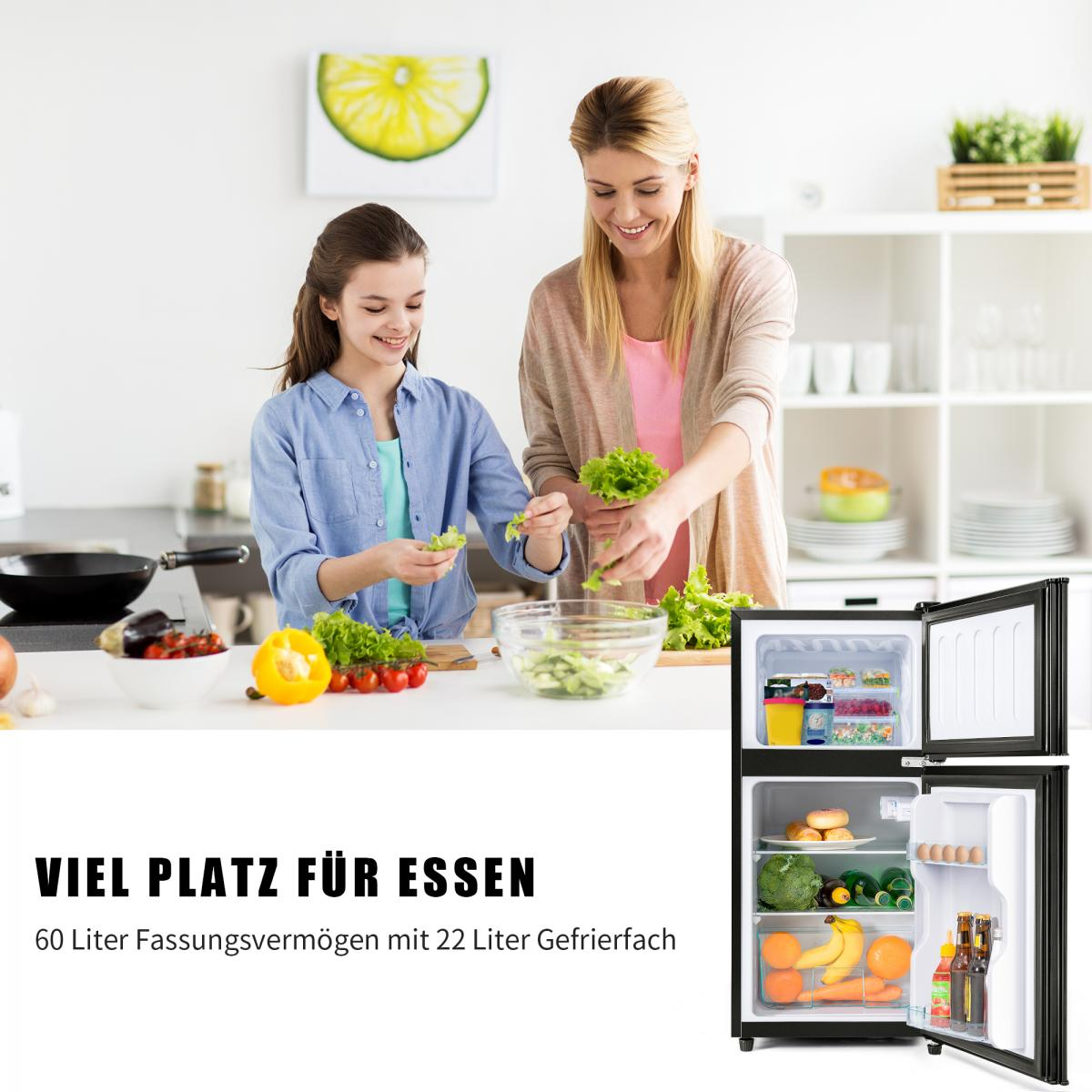Mutter und Tochter bereiten Salat in einer Küche zu, daneben ein offener Kühlschrank.