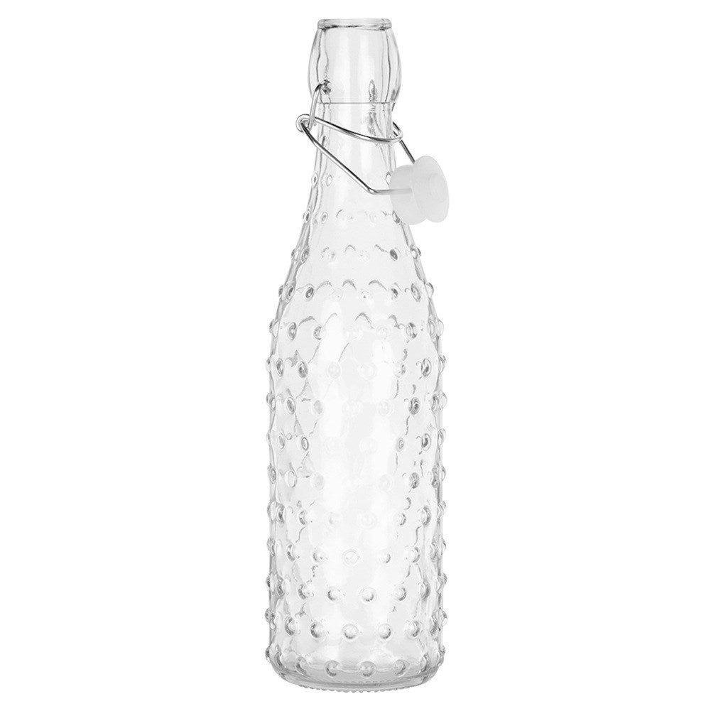 Una botella de vidrio transparente con tapa abatible y superficie texturizada.