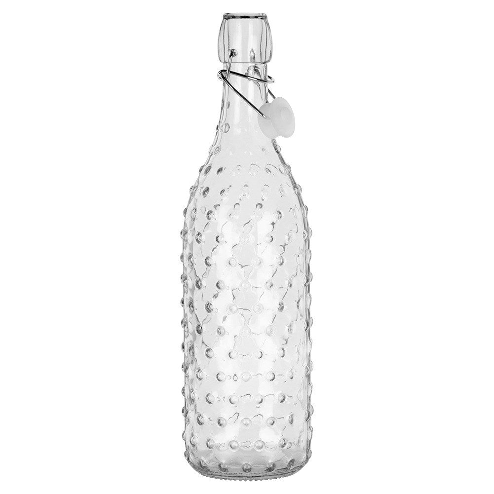 Una botella de vidrio transparente con patrón en relieve y tapa abatible.