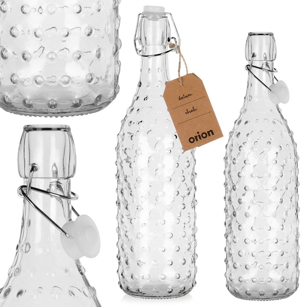 Tres botellas de vidrio con relieve. Una botella tiene una etiqueta marrón.