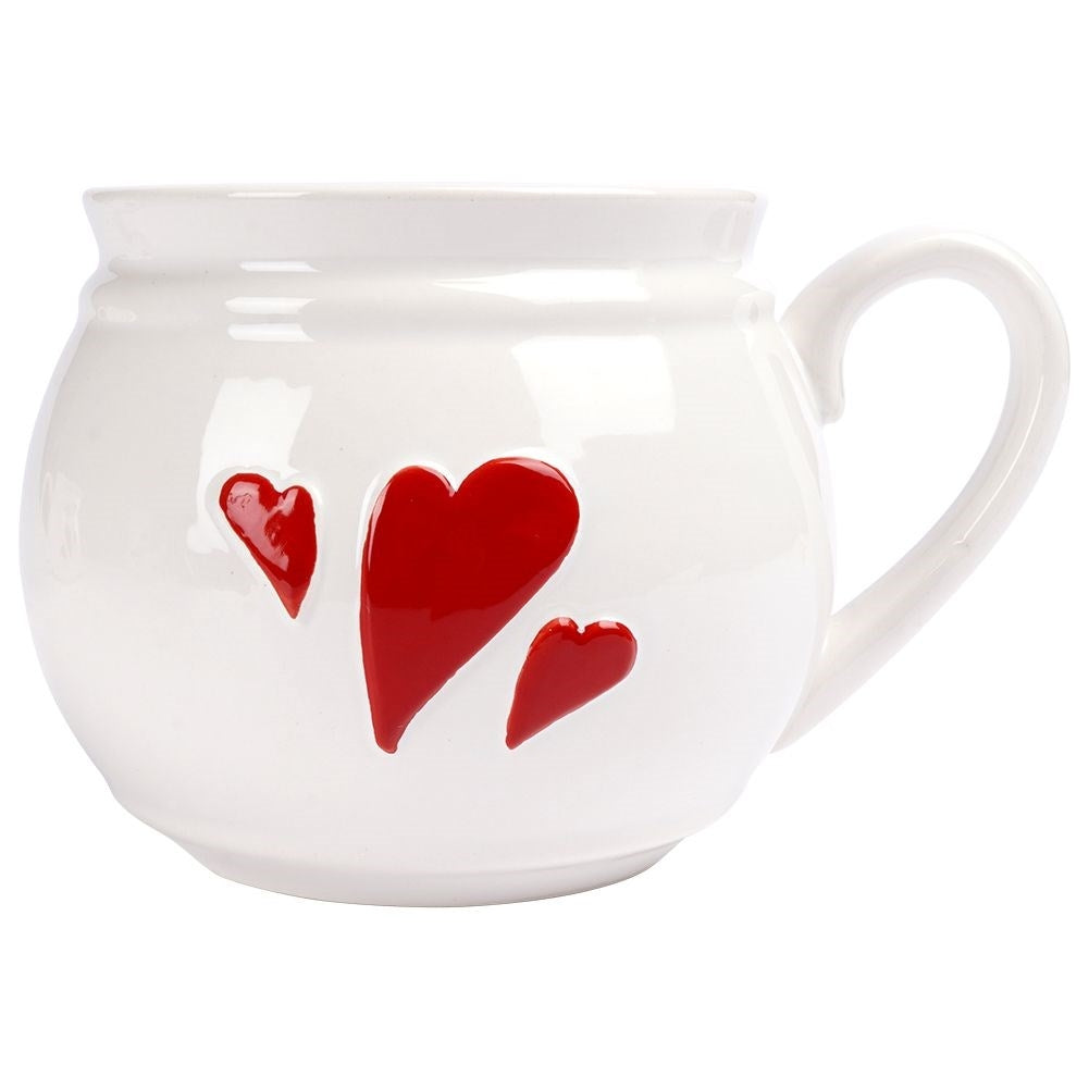 Taza blanca con corazones rojos