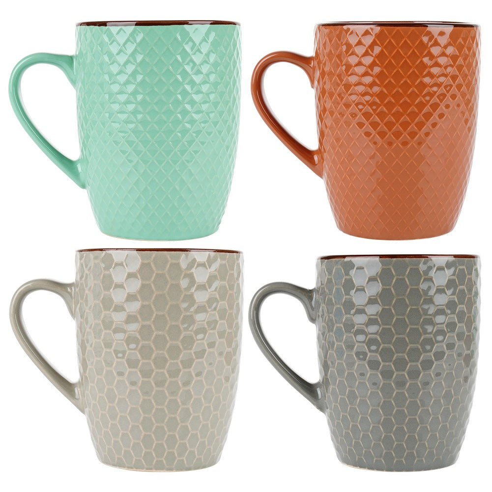 Cuatro tazas texturizadas en verde menta, naranja, gris claro y gris.