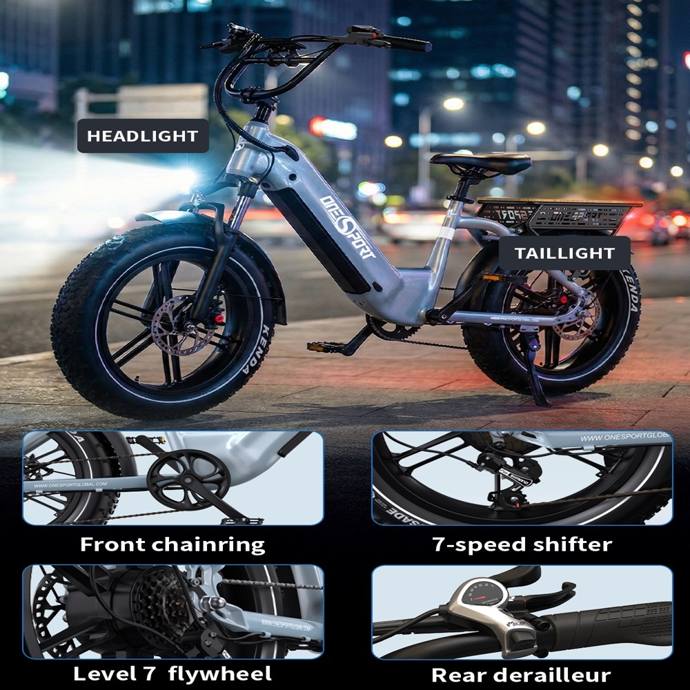 E-bike gris con neumáticos anchos, cesta, faro y luz trasera.
