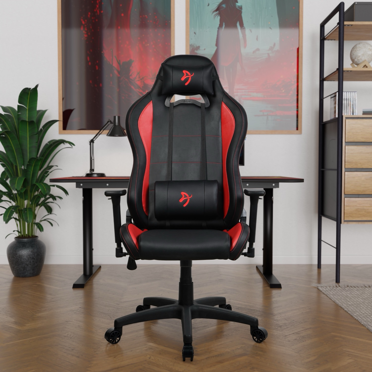 Een zwarte gamestoel met rode accenten staat voor een bureau.