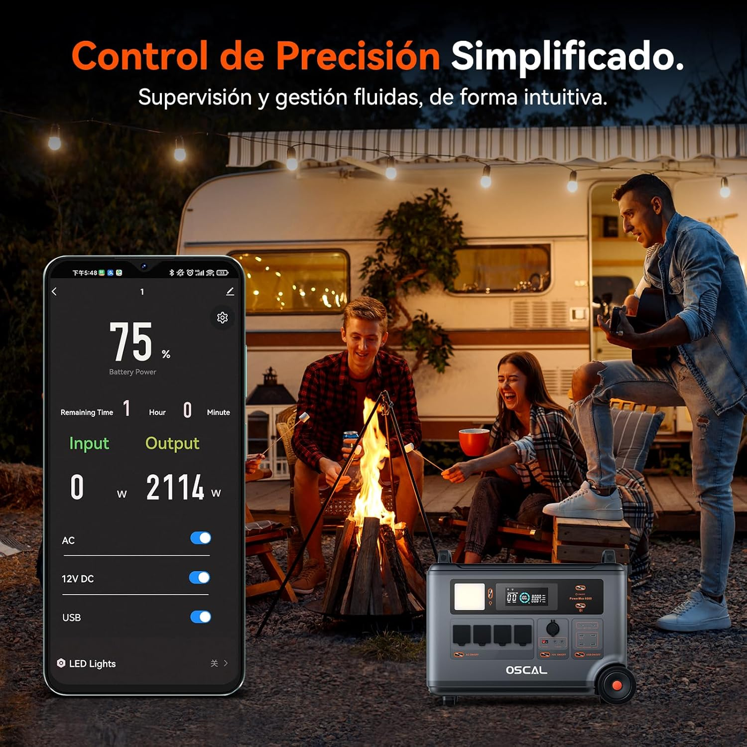 Gente sentada junto a una fogata delante de una autocaravana, una persona usa un smartphone.