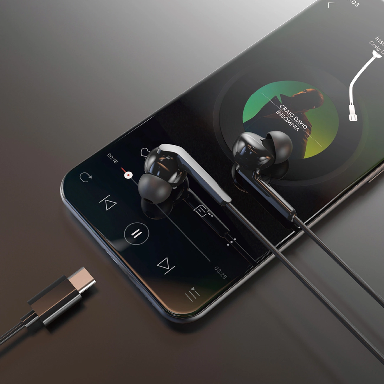 Auricolari neri su smartphone che riproduce musica. Un cavo USB-C nelle vicinanze.