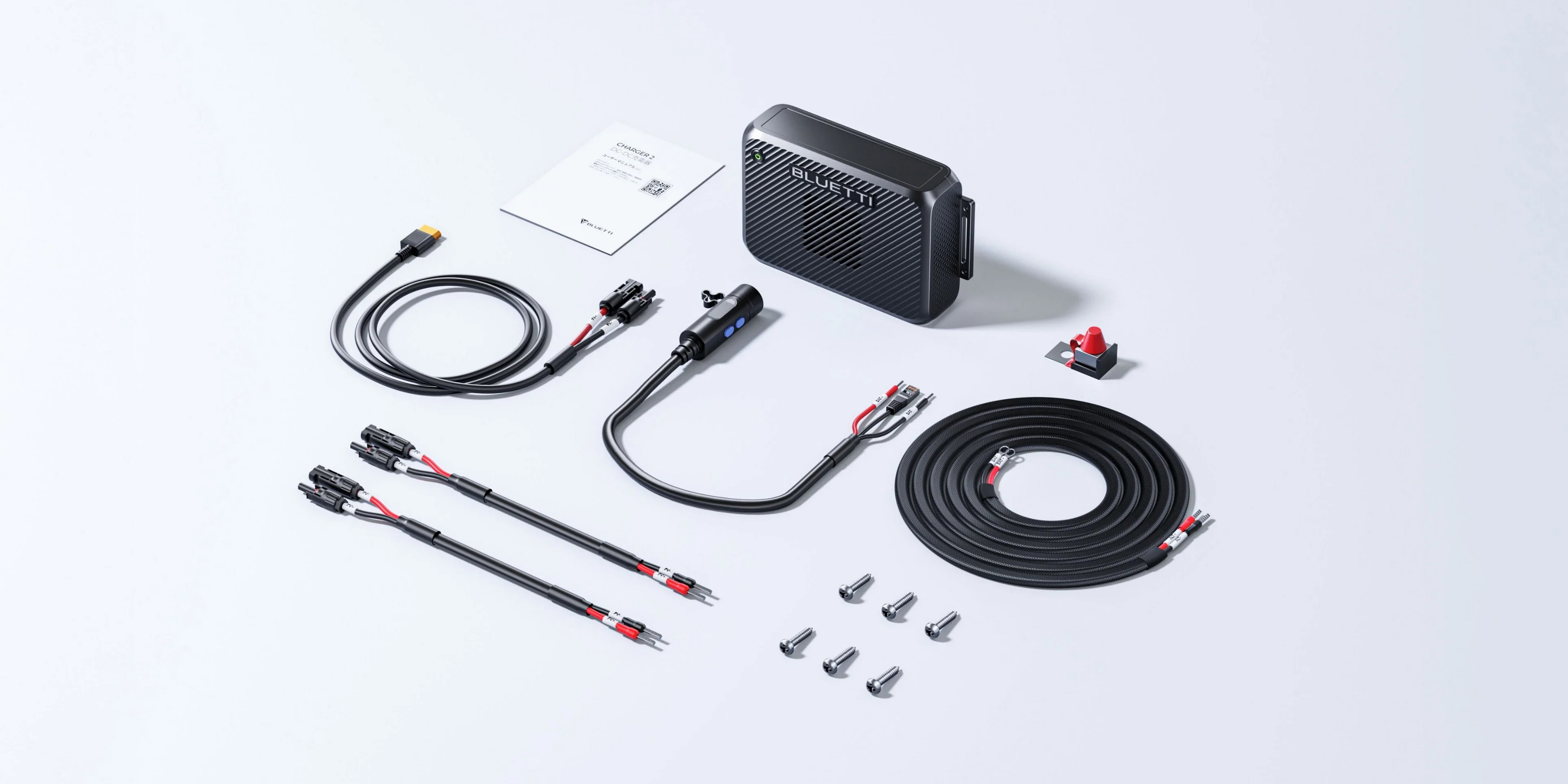 Czarne urządzenie z kablami, śrubami i instrukcją.