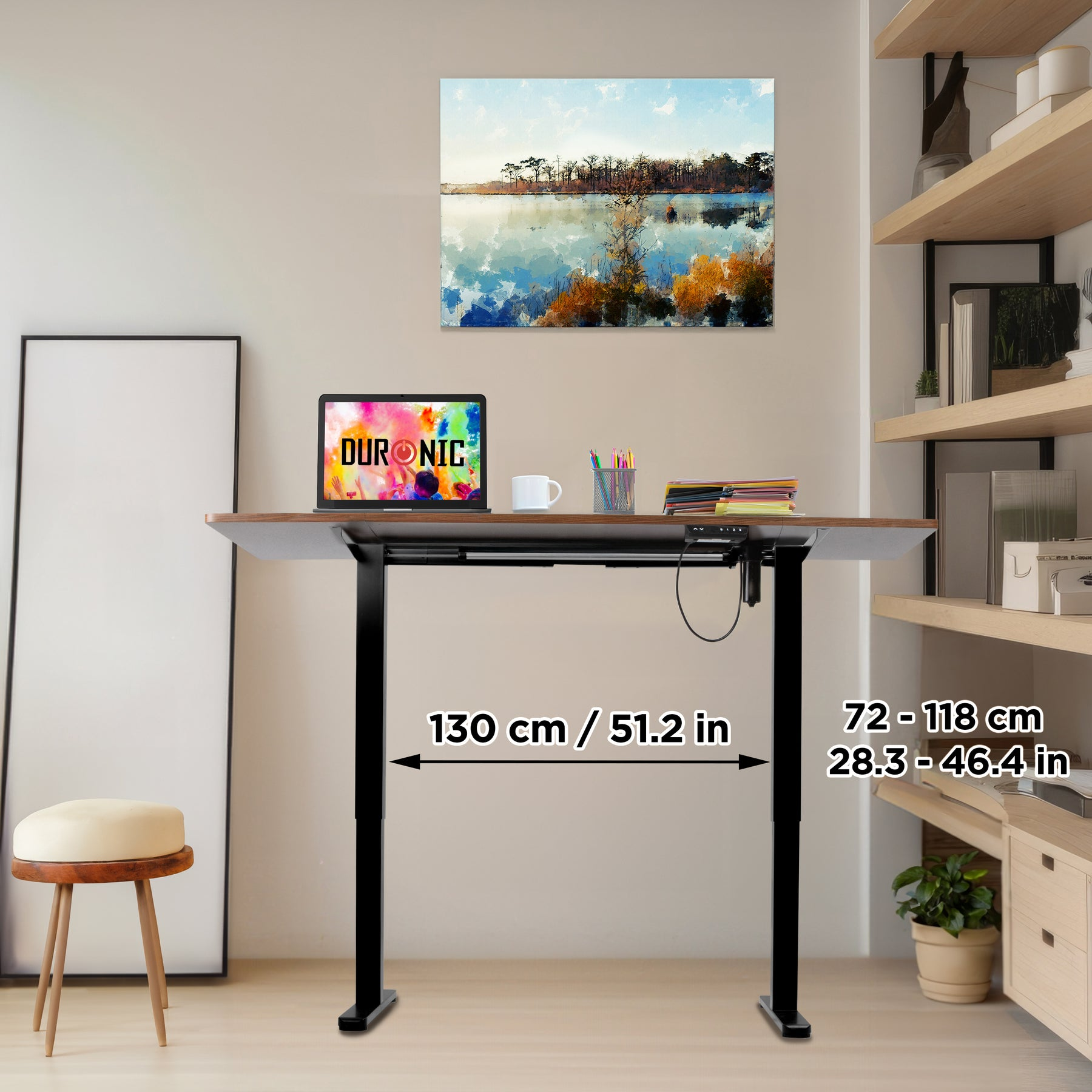 Höhenverstellbarer Schreibtisch mit Laptop, Tasse, Stiften und Gemälde.