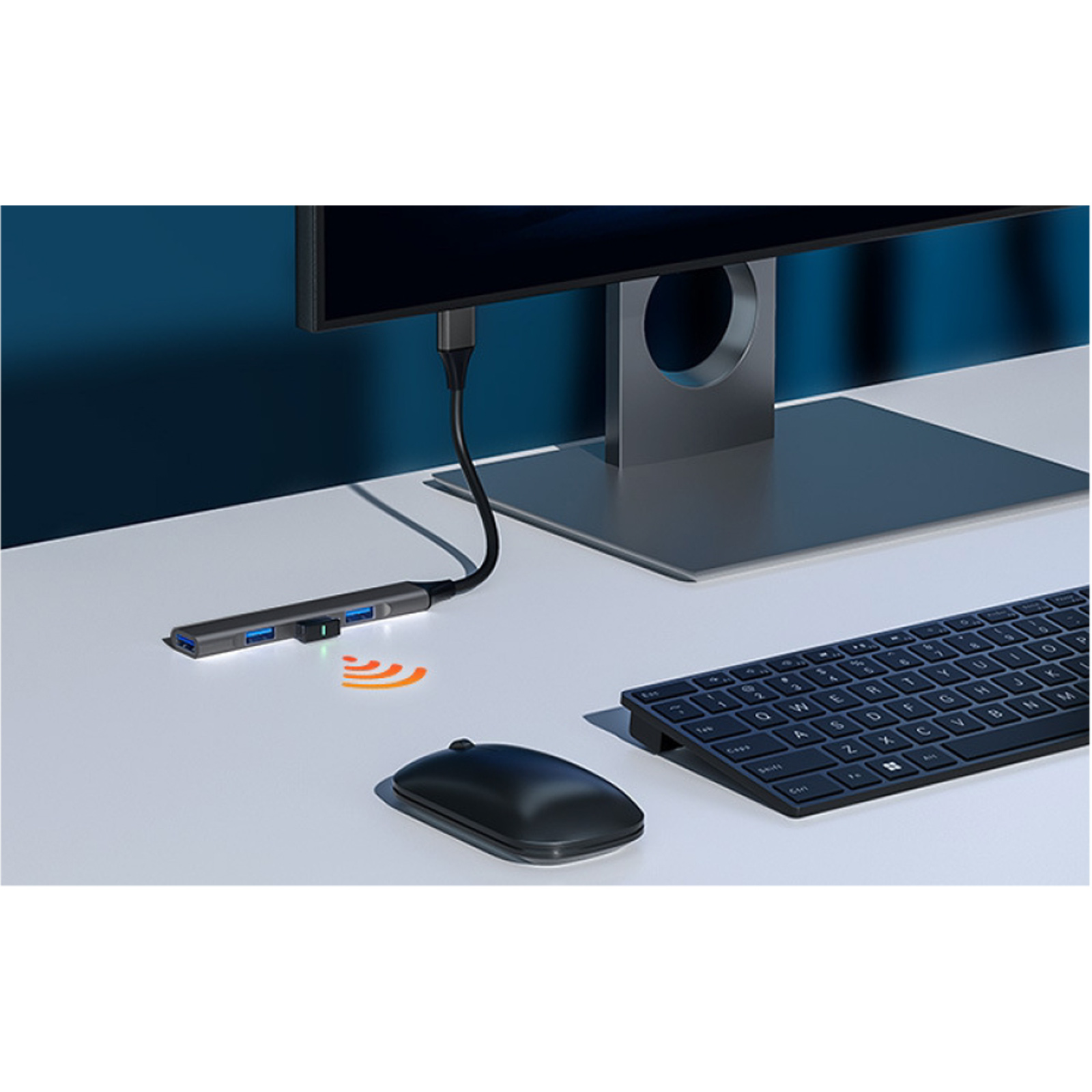 Un concentrador USB con puertos, ratón y teclado delante de un monitor.