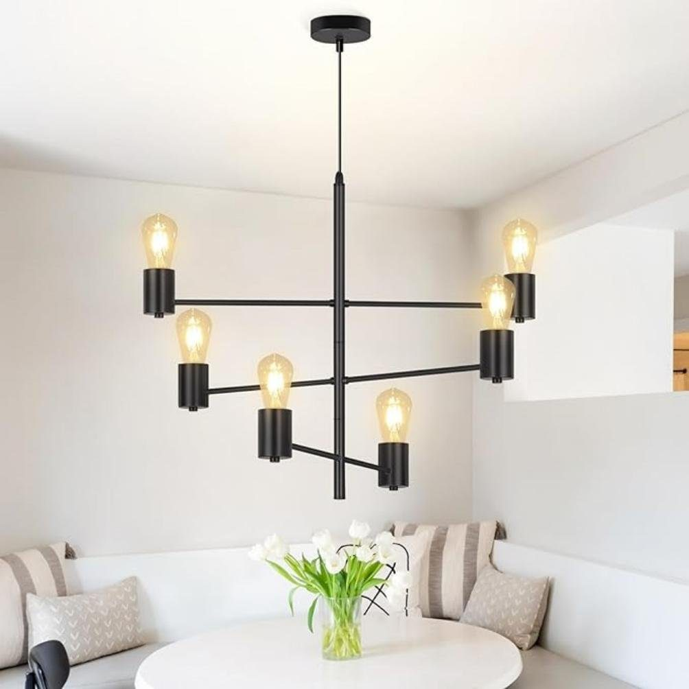 Czarny żyrandol z sześcioma żarówkami wisi nad okrągłym stołem.