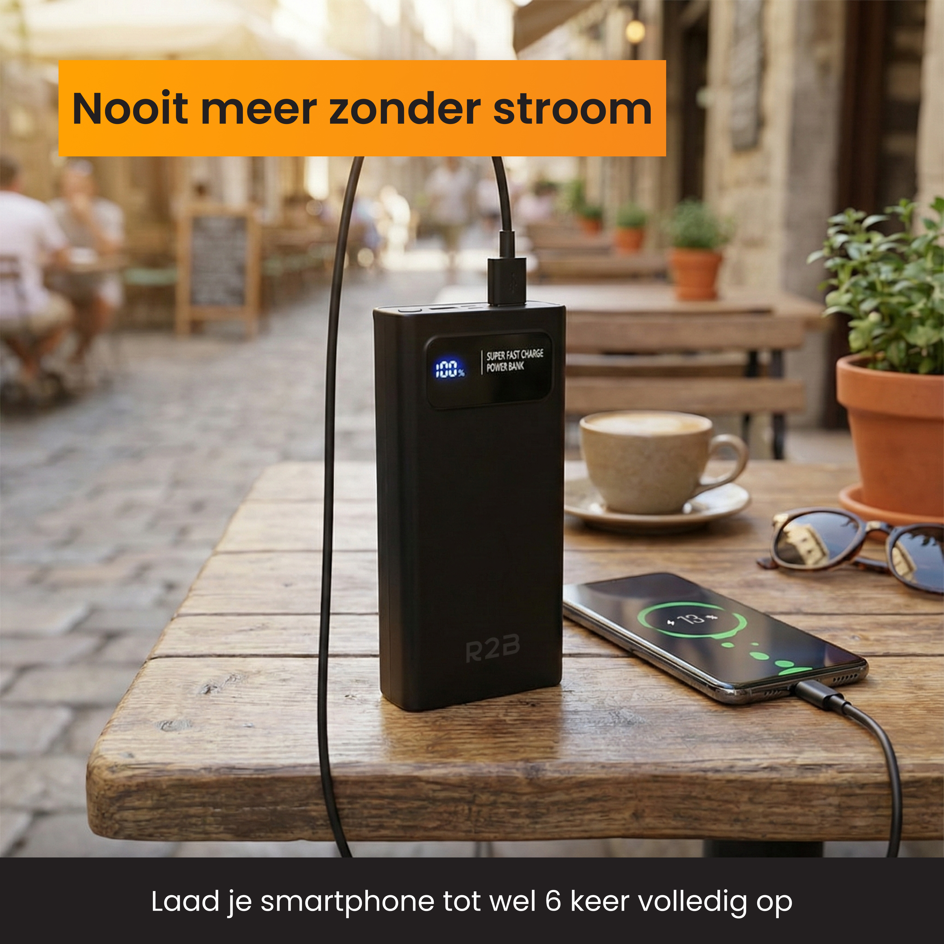 Black power bank charges a smartphone on a wooden table. Outdoors.