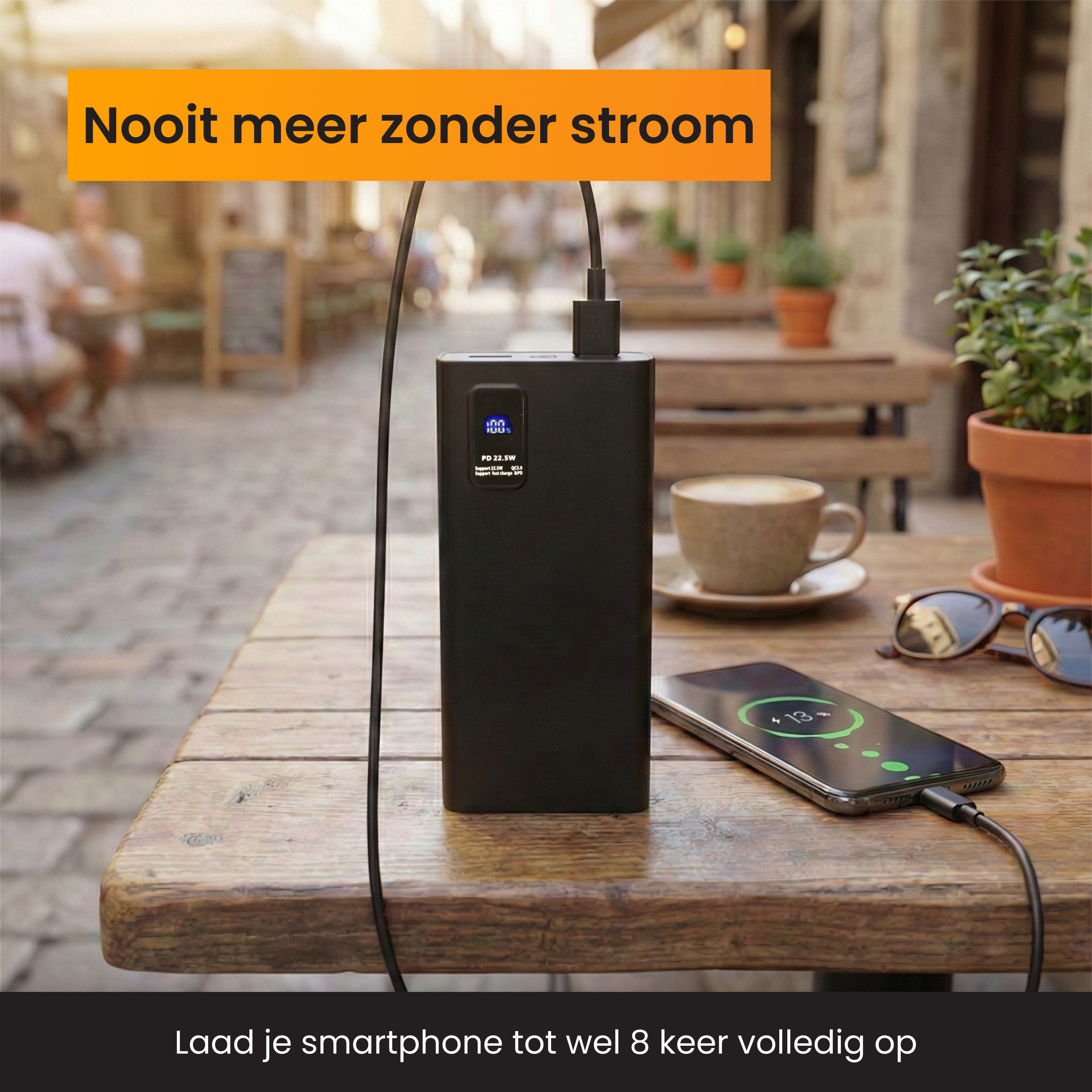 Black power bank charges a smartphone on a wooden table.