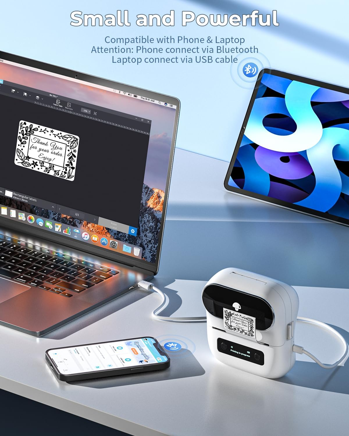 Un ordinateur portable, un smartphone et une tablette avec une petite imprimante sur un bureau.