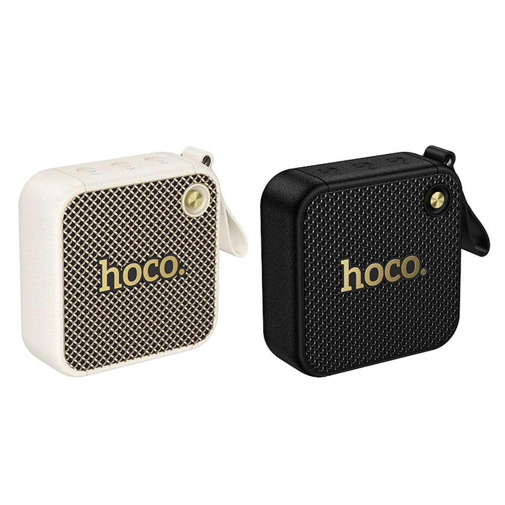 Dos altavoces Hoco: uno blanco, uno negro, ambos con logo dorado.