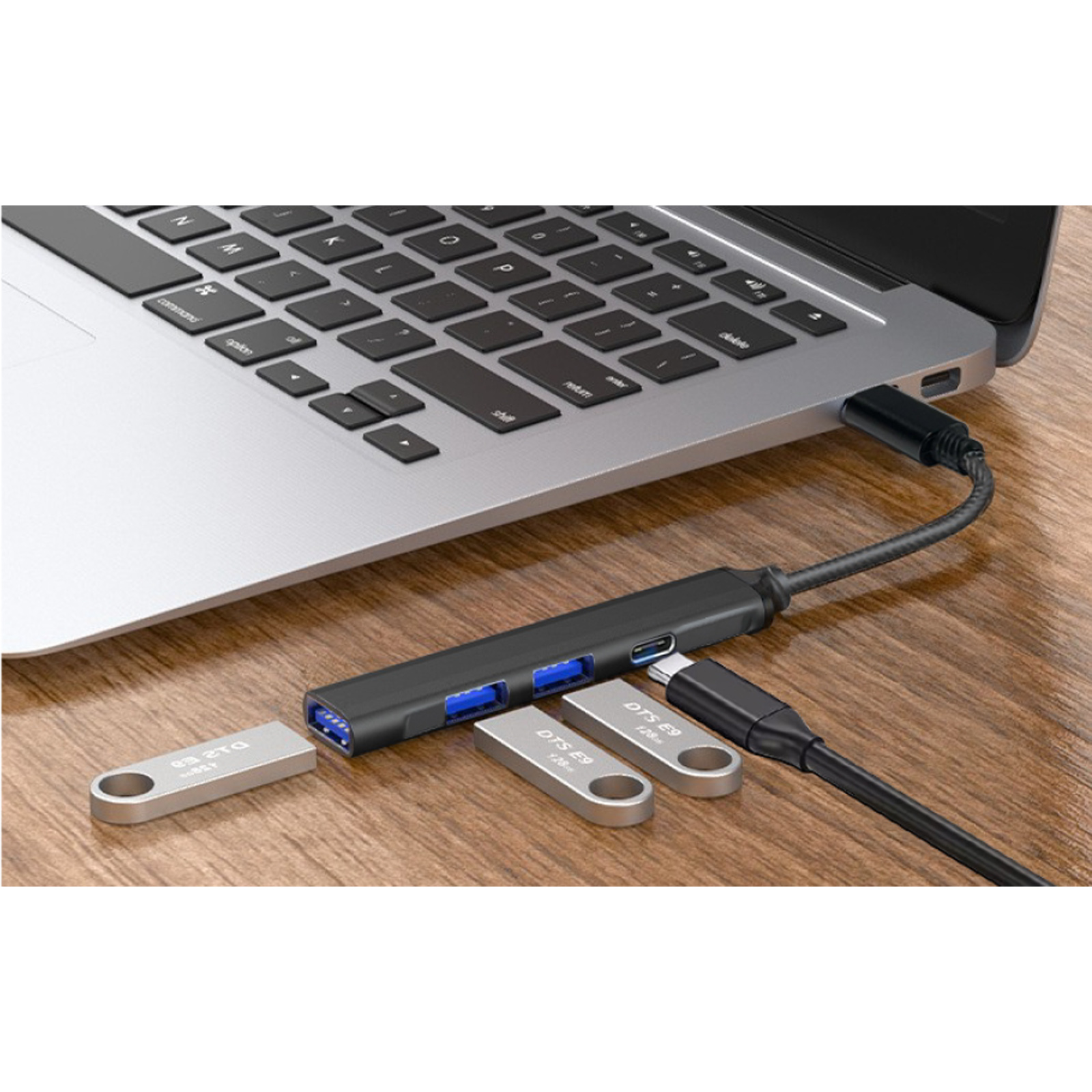 Un hub USB multi-porta è collegato a un laptop, con chiavette USB nelle vicinanze.