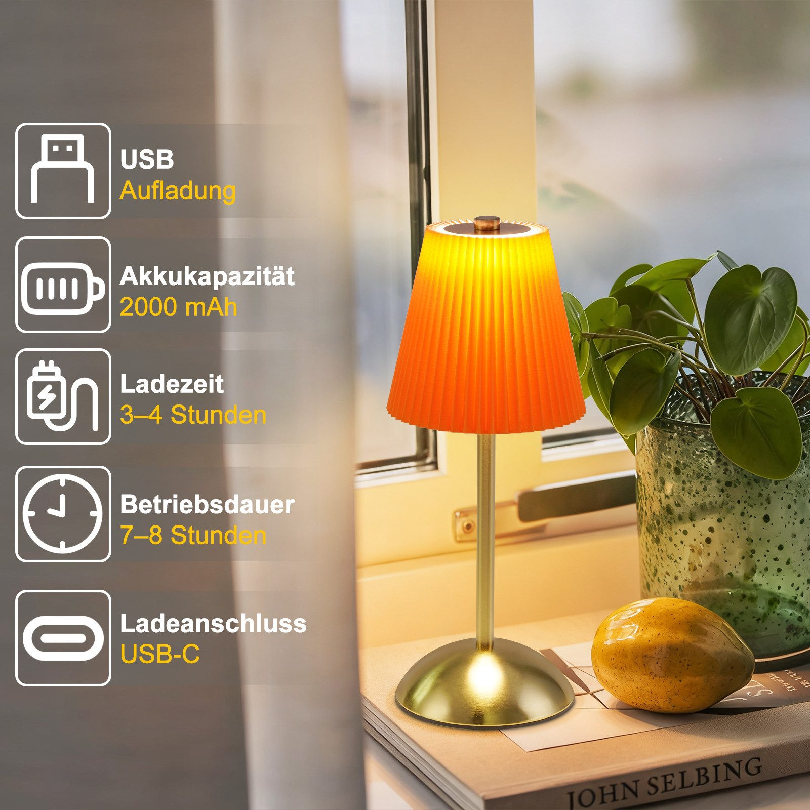 Una lampada arancione con USB-C, accanto a un libro e un frutto.