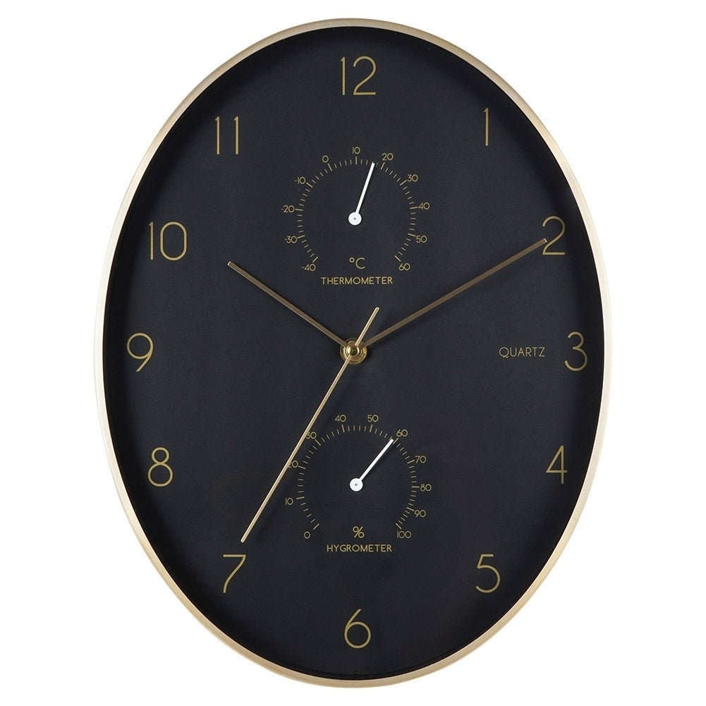 Reloj de pared negro con termómetro e higrómetro, marco dorado.