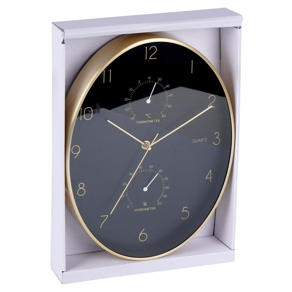 Un reloj de pared negro con marco dorado e higrómetro/termómetro incorporado.