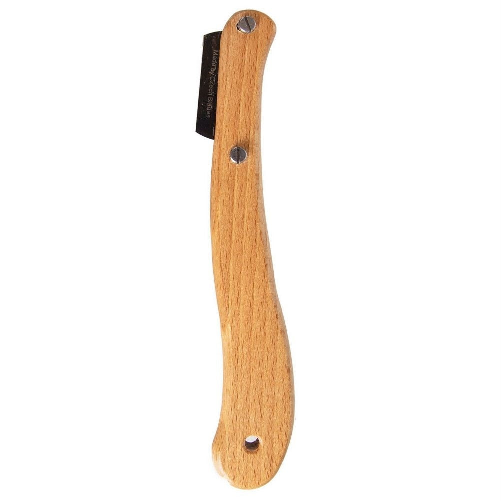 Un mango de madera con un disco de metal y un agujero al final.