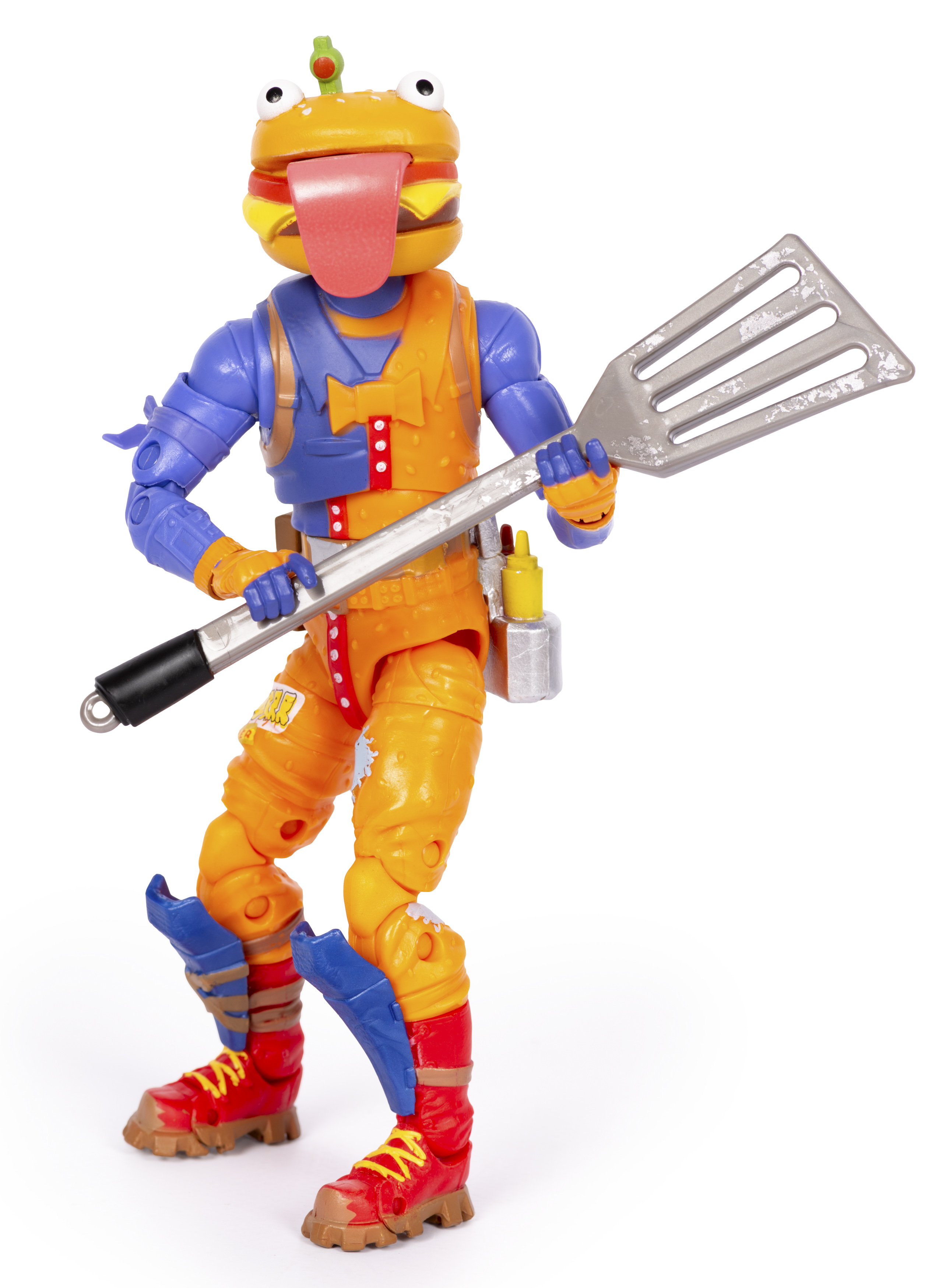 Eine Figur mit Burgerkopf, blauer und oranger Kleidung, hält einen Pfannenwender.