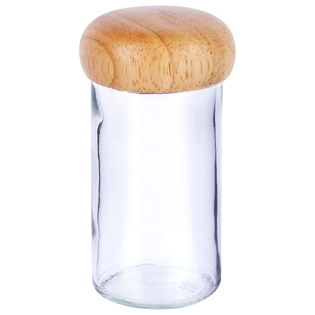 Un frasco de vidrio vacío con tapa redonda de madera.
