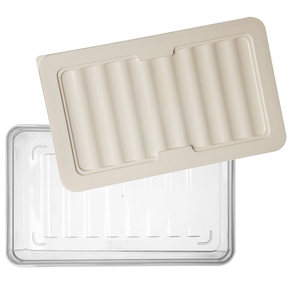 Una caja de almacenamiento transparente con una tapa acanalada color crema encima.
