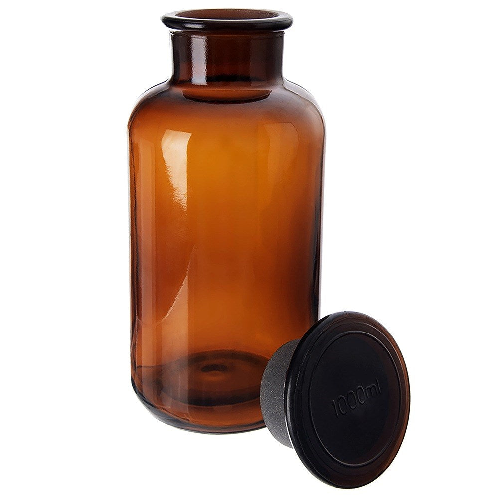 Botella de vidrio ámbar con tapón negro de 1000ml al lado.